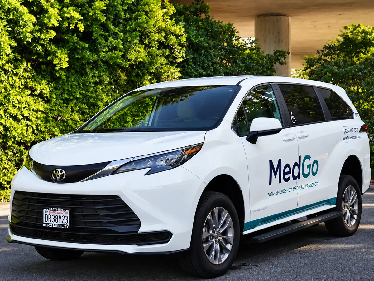 The MedGo Transportation wheelchair-accessible van parked in front of a hedge in Los Angeles.