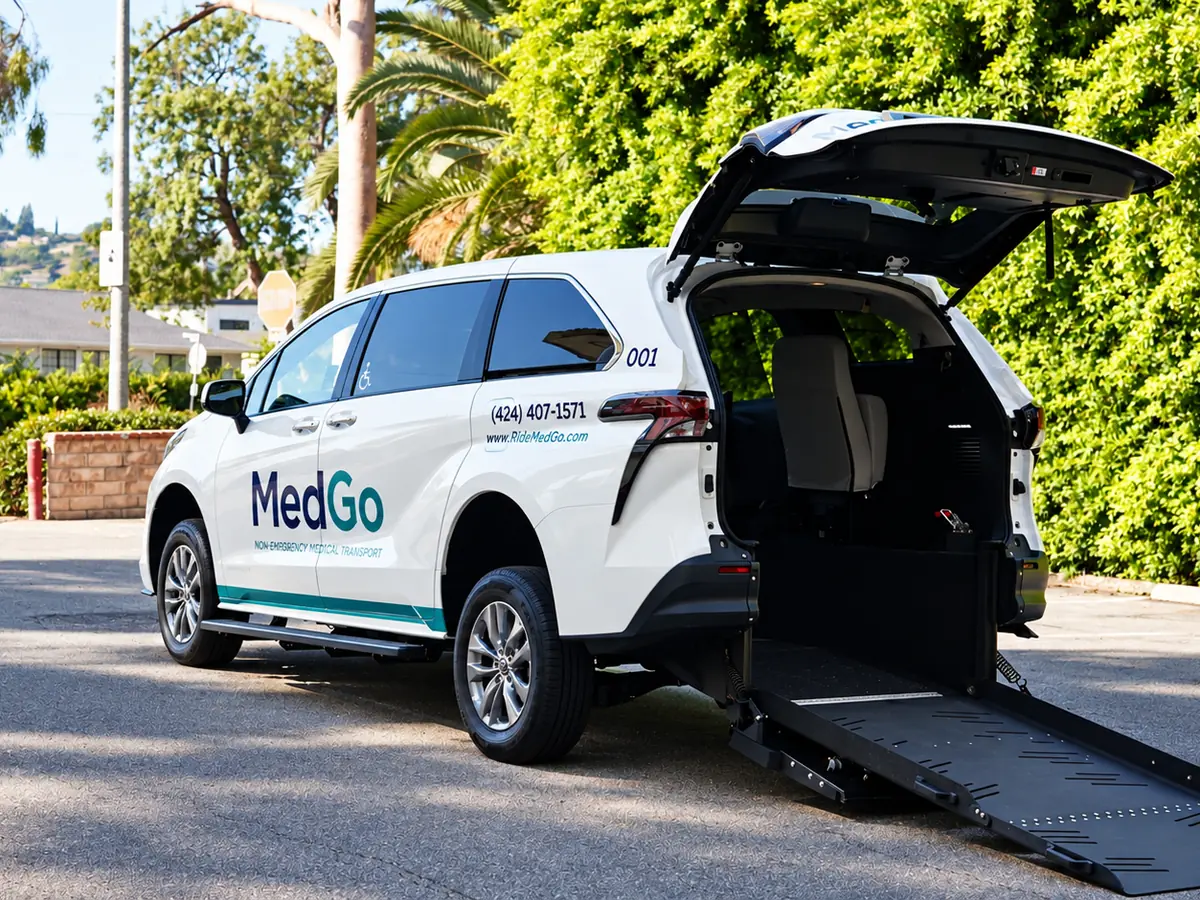 The MedGo Transportation van with its rear wheelchair ramp lowered on a quiet street.